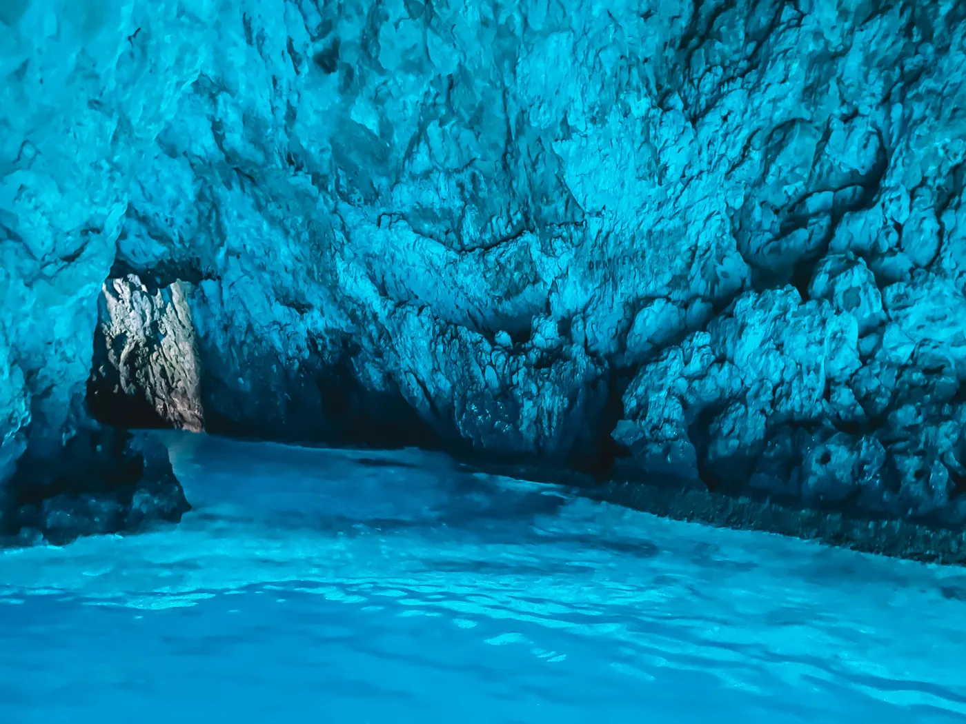 Inside the Blue Cave, electric-blue water and the cave's entrance